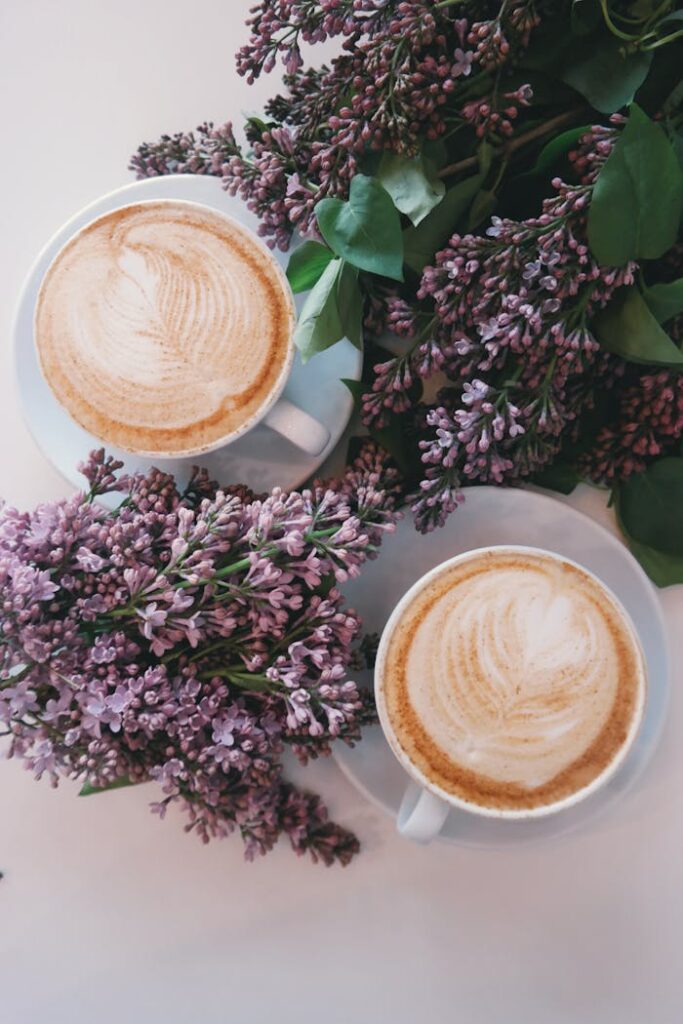 pexels photo 377903 Artistic latte art surrounded by blooming lilac flowers creates a cozy, aesthetic vibe.